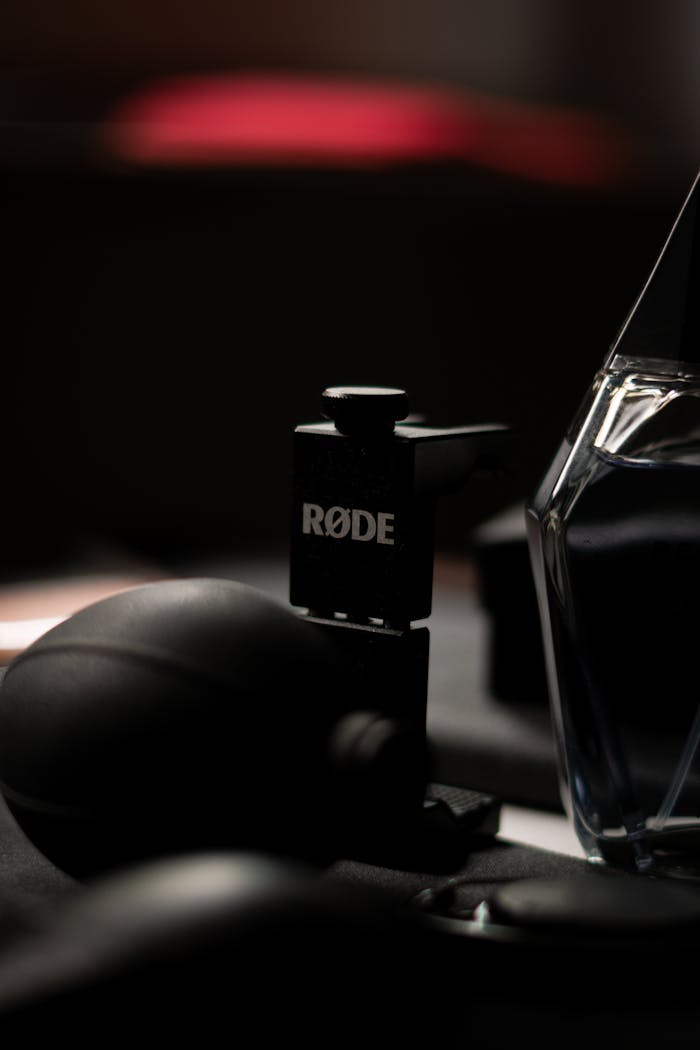 Close-up shot of a RØDE microphone stand in dark, moody lighting, perfect for audio equipment themes.